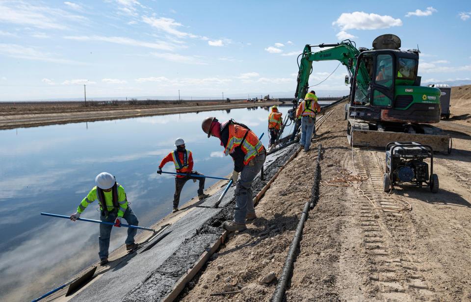 Image shows construction workers making subsidence repairs to the California Aqueduct near Lost Hills in Kern County. 