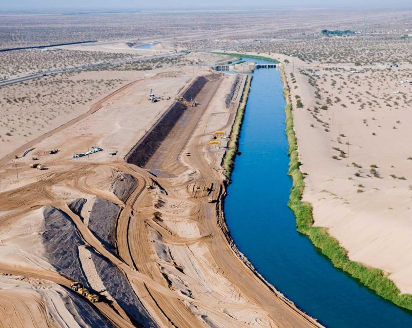 Image shows the All-American Canal as a portion of a new channel was being lined.