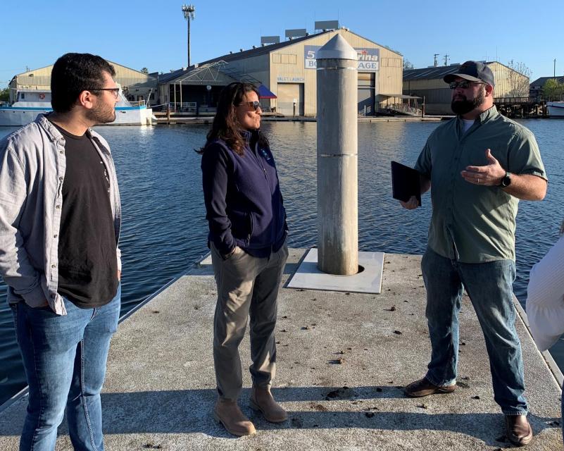 EPA Region 9 Administrator Martha Guzman stands at a dock during a tour of the Port of Stockton with Matt Holmes, environmental justice outreach coordinator with Little Manila Rising, and  Spencer Fern, Delta science coordinator with Restore the Delta. 
