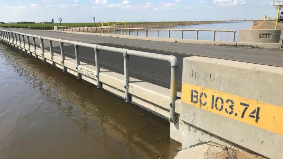 Water is up to the bottom of a bridge crossing the Friant-Kern Canal due to subsidence caused by overpumping of groundwater. 