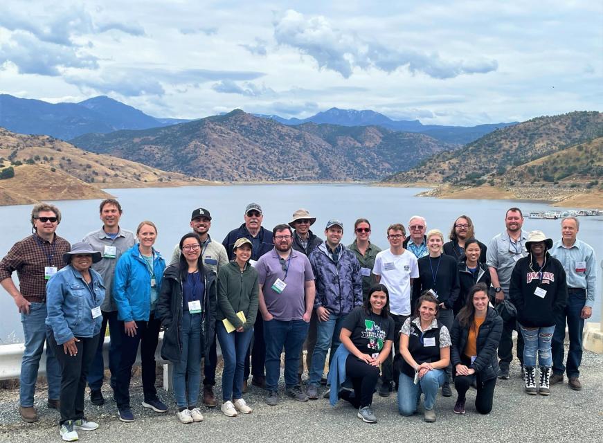 Image shows participants on our Central Valley Tour posing in front of a reservoir.