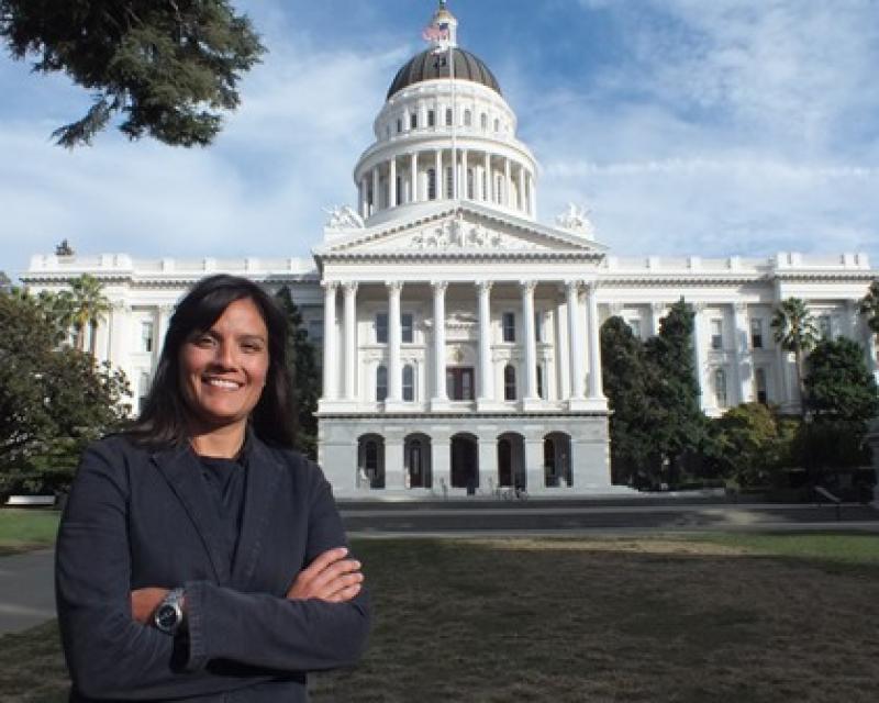 Martha Guzman poses in front of the California State Capitol during her time as a deputy legislative secretary for then-Gov. Jerry Brown.