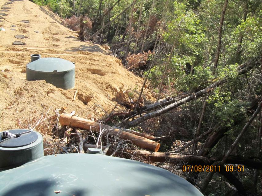 These water tanks at at illegal growing operation were in a stream that the grower filled in. Trees and debris were cast into the stream at right. 