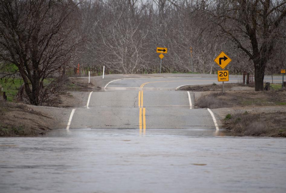 Floodwaters inundate a roadway in the Sacramento Valley.