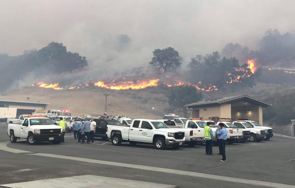 Flames from the 2018 Woolsey Fire approach Las Virgenes Municipal Water District buildings.  