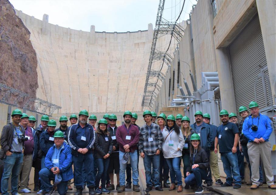 Lower Colorado River Tour poses in front of Hoover Dam on the Colorado River.