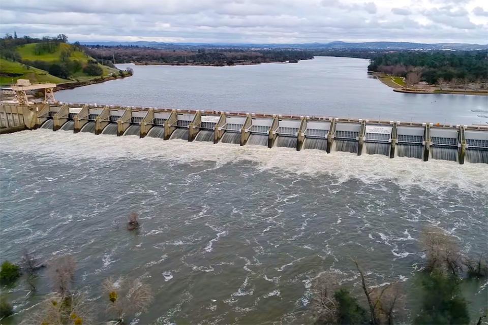 Image shows an aerial view of Nimbus Dam on the American River
