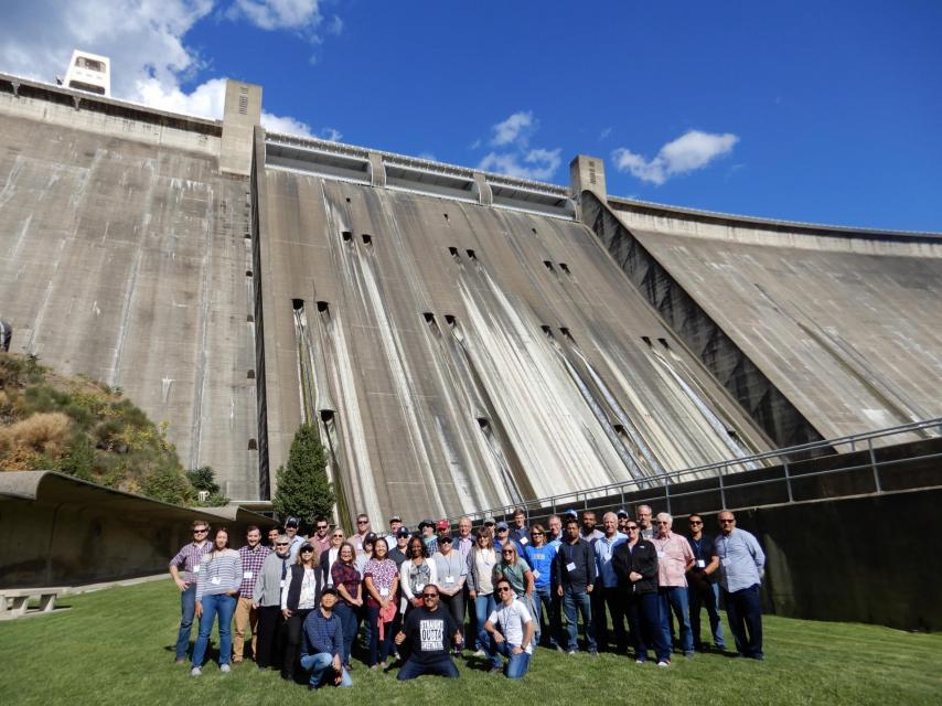 Water Education Foundation tour group stands in front of Shasta Dam.
