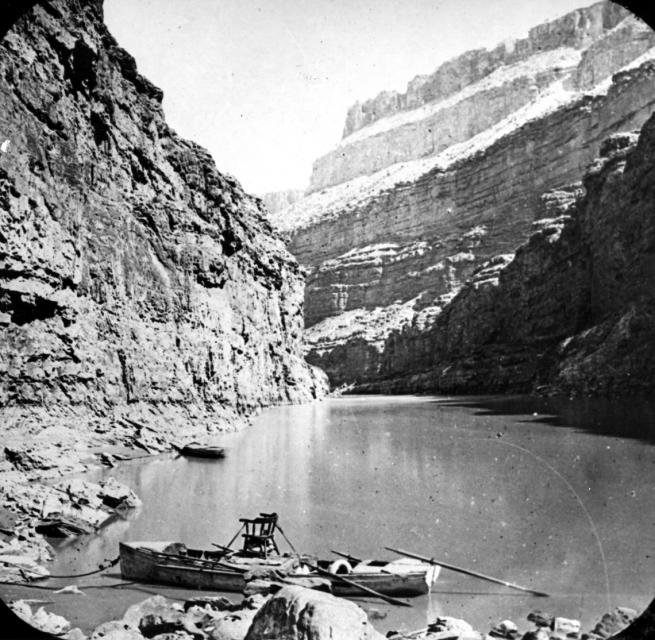 A stopover during Powell's second expedition down the Colorado River. Note Powell's chair atop the center boat. 