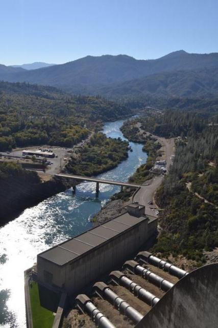 The photo shows the Sacramento River as it flows beyond Shasta Dam and its powerhouse. 