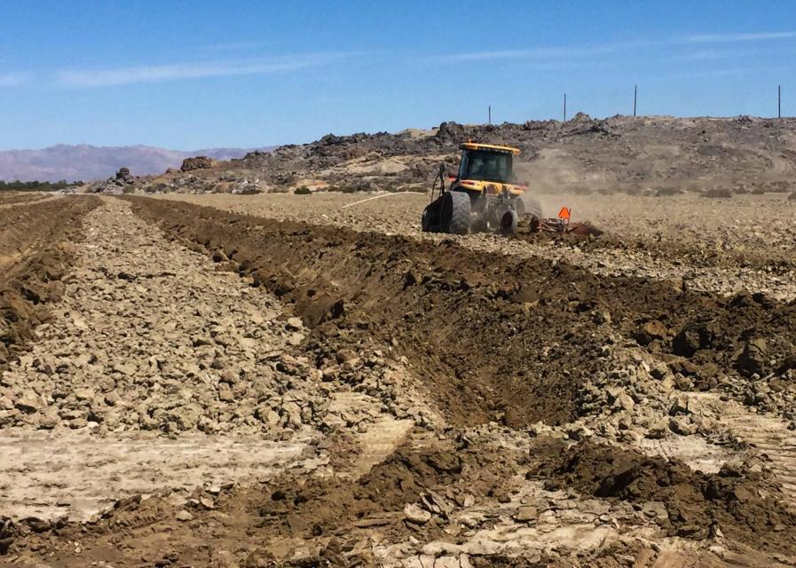 As dust blows across roughened surfaces, some of it falls into deep furrows, reducing what remains in the air.  Deep furrows are carved into the playa to help suppress blowing dust along the receding shoreline of the Salton Sea. 