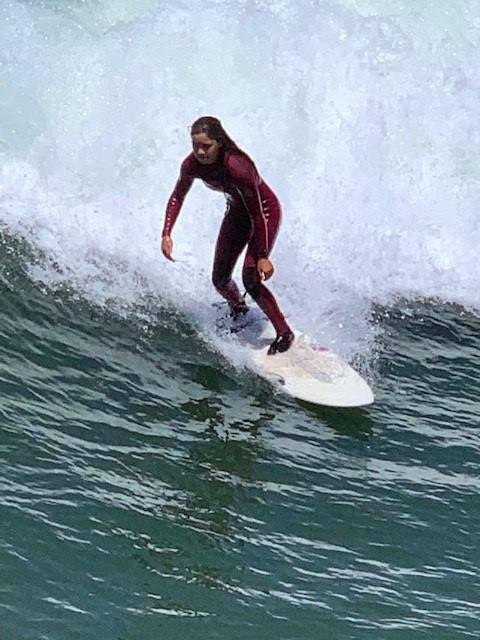 Photograph of a surfer riding a wave off of Imperial Beach, near the border with Mexico. 