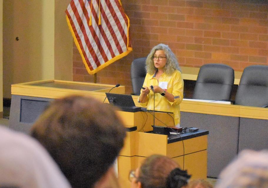 Image shows a speaker addressing the audience at Water 101 Workshop.