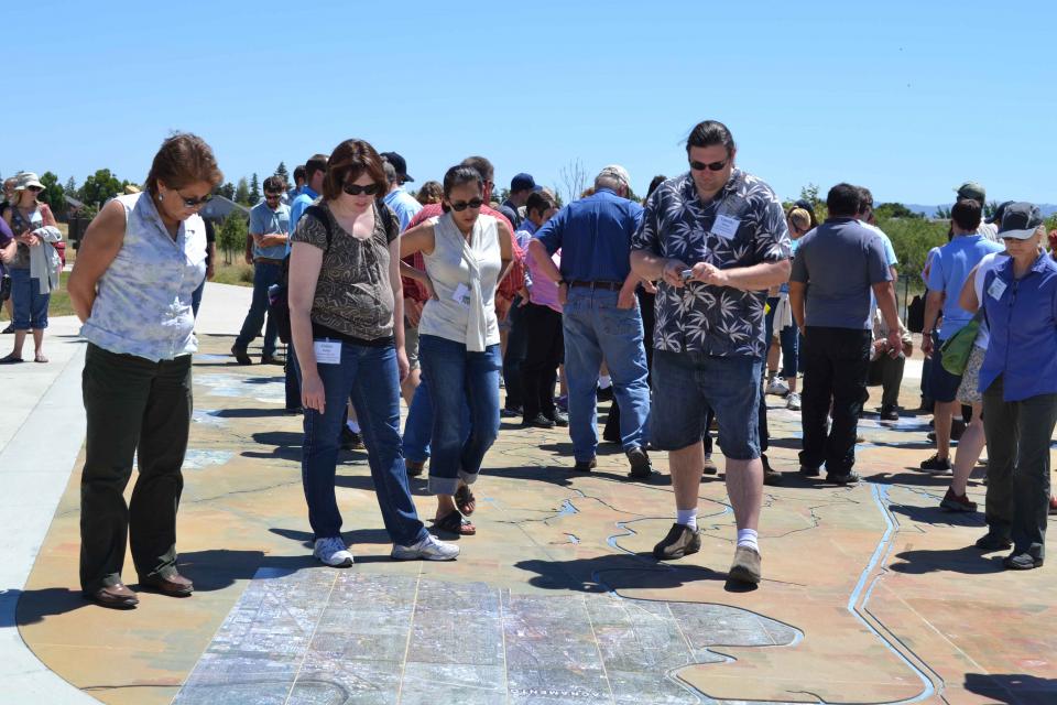 Visitors explore a large, three-dimensional map of the Sacramento-San Joaquin Delta at Big Break Regional Shoreline in Oakley. 