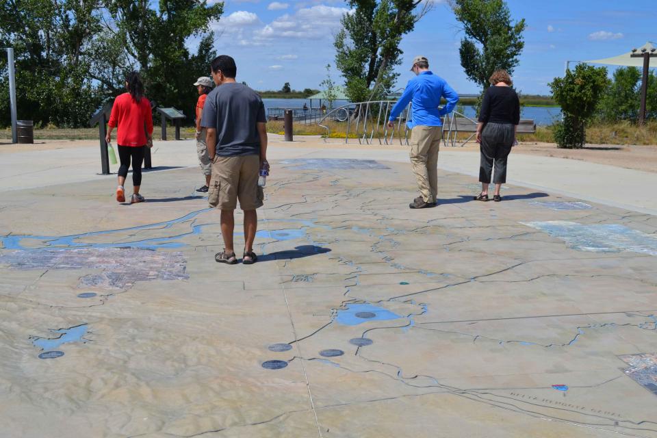 Visitors explore a large, three-dimensional map of the Sacramento-San Joaquin Delta at Big Break Regional Shoreline in Oakley. 