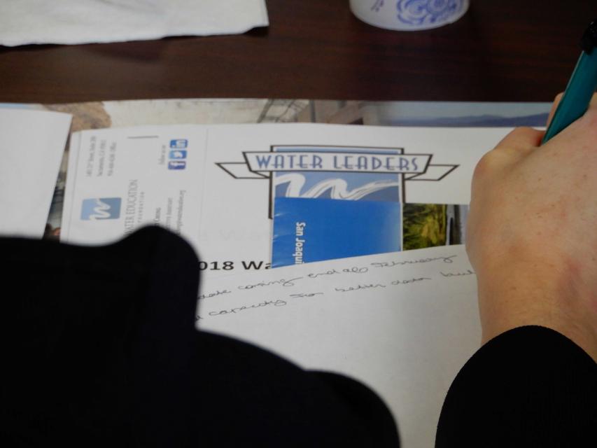 Water Leader takes notes during an orientation session. 