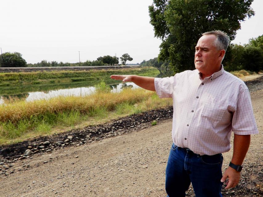 Roger Cornwell, general manager of River Garden Farms near Knights Landing, standing atop a levee along the Sacramento River, points to how little shelter exists along the river. 