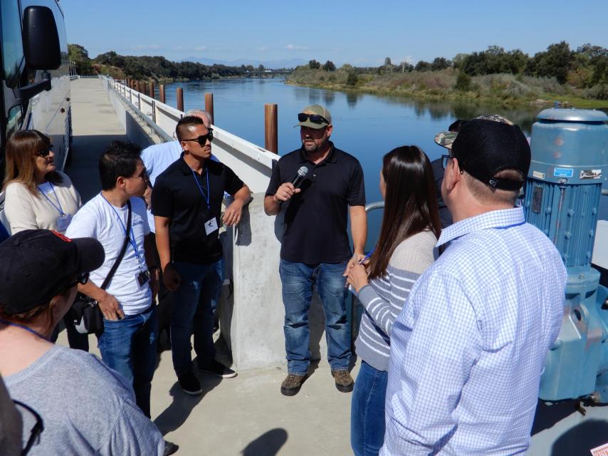 Image shows participants on our Northern California Tour along the Sacramento River.