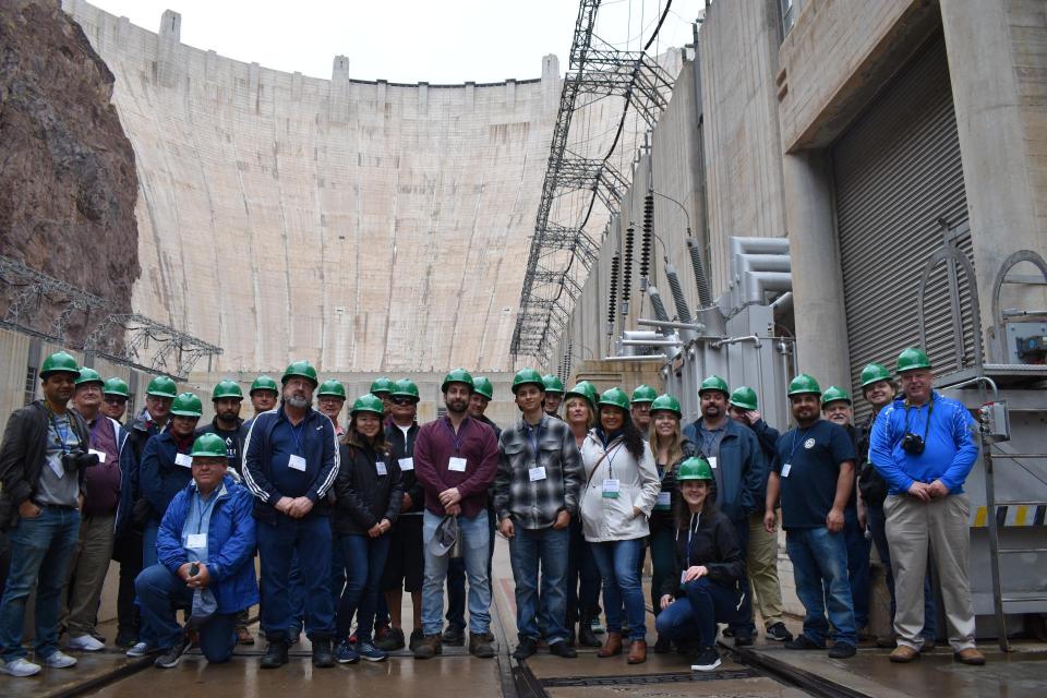 Lower Colorado River Tour participants gather in front of Hoover Dam for a group photo. 