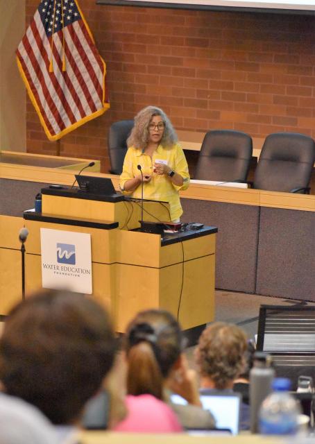 Image shows a presenter and some of the audience at Water 101 Workshop